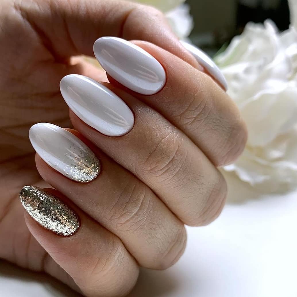 Clean White Almond Nails with Gold Glitter Accents