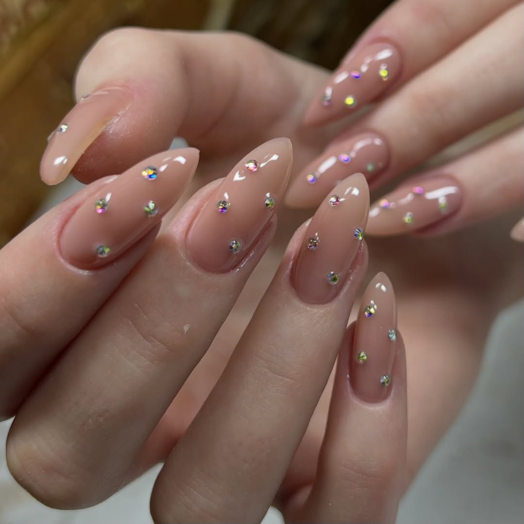 Clear Nude Glossy Almond Nails With Scattered Rhinestones