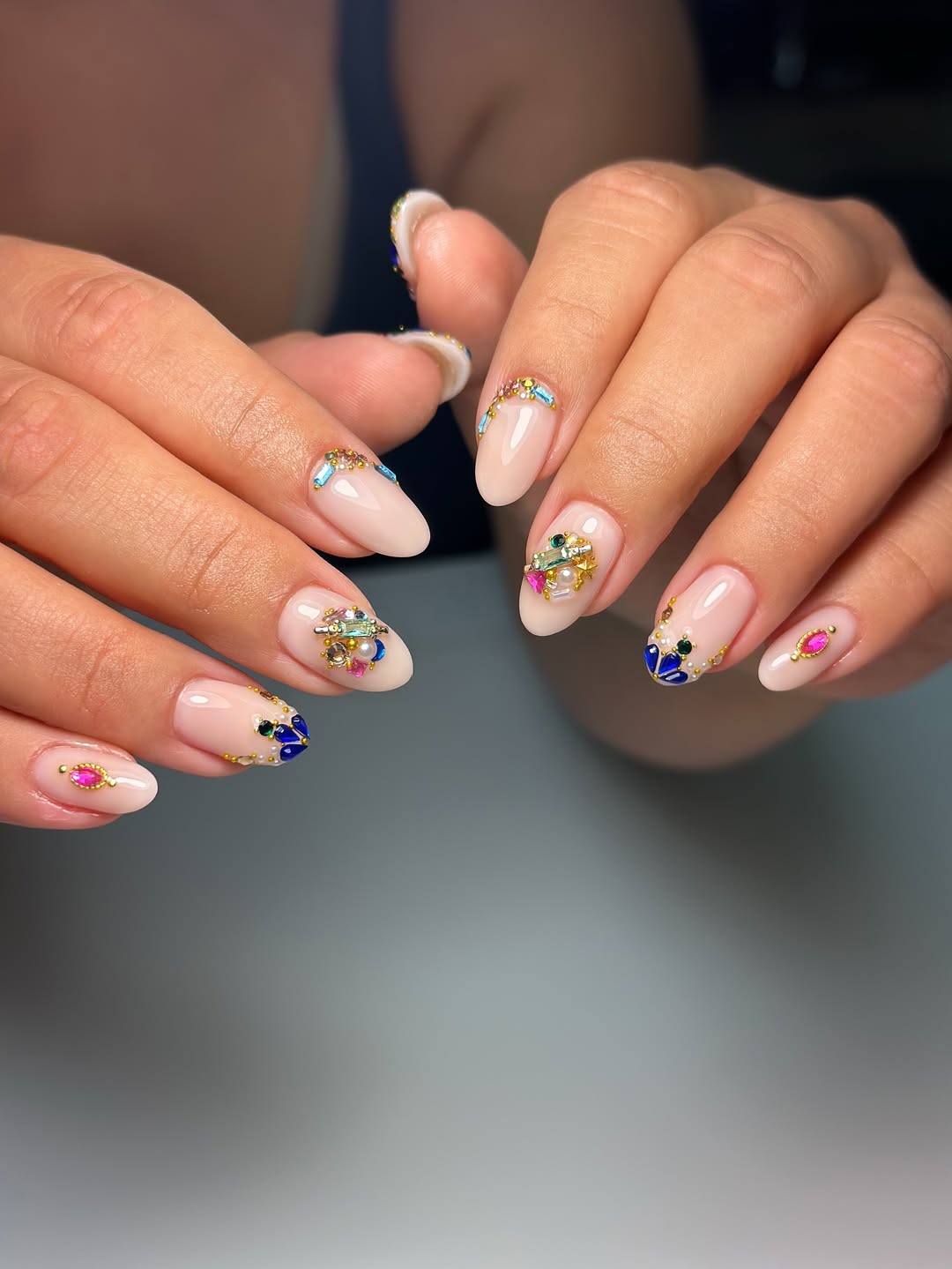 Glamorous Nude Almond Nails With Colorful Gemstone Tips
