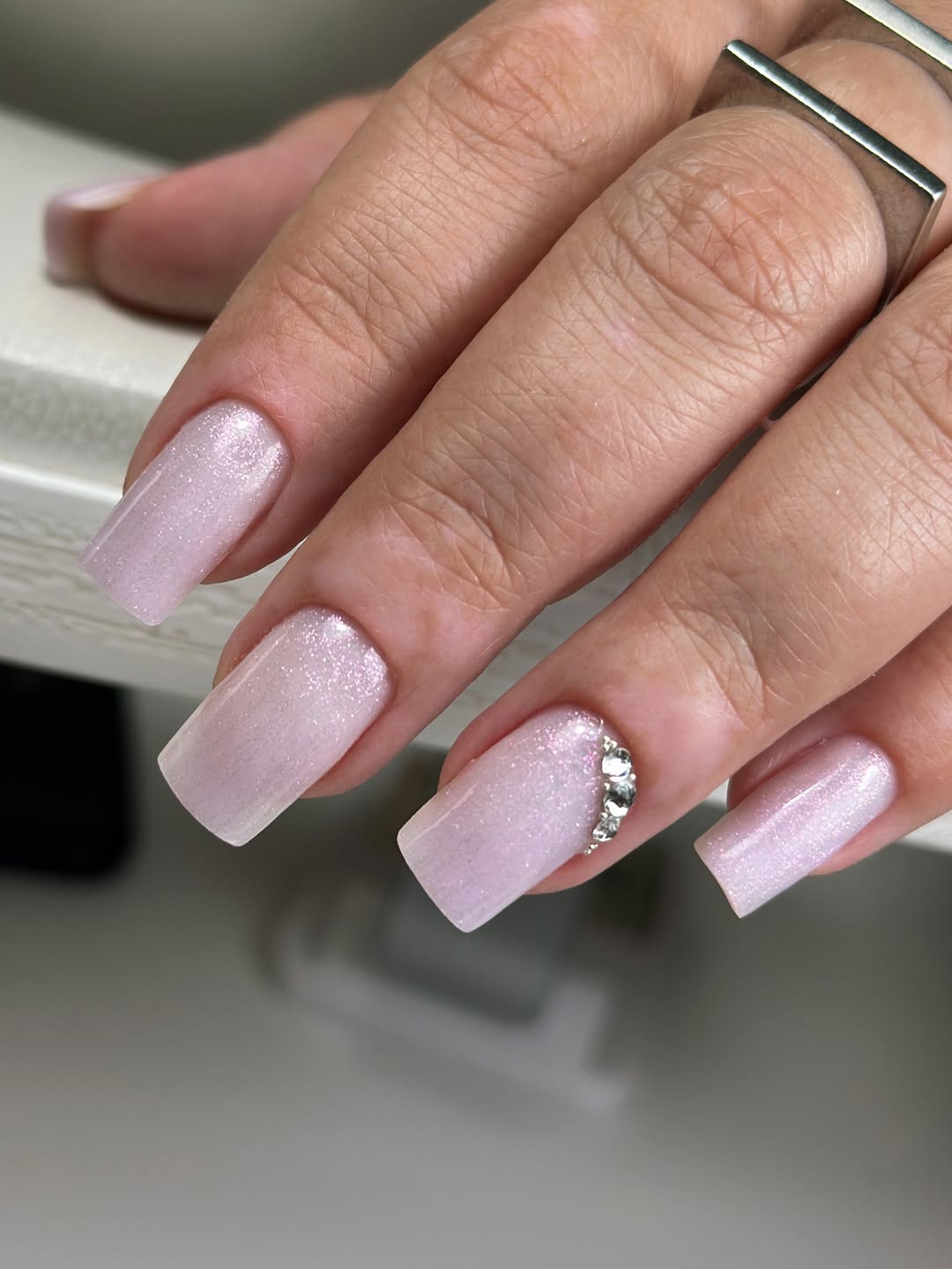 Glittery Pink Almond Nails with Rhinestone Detail