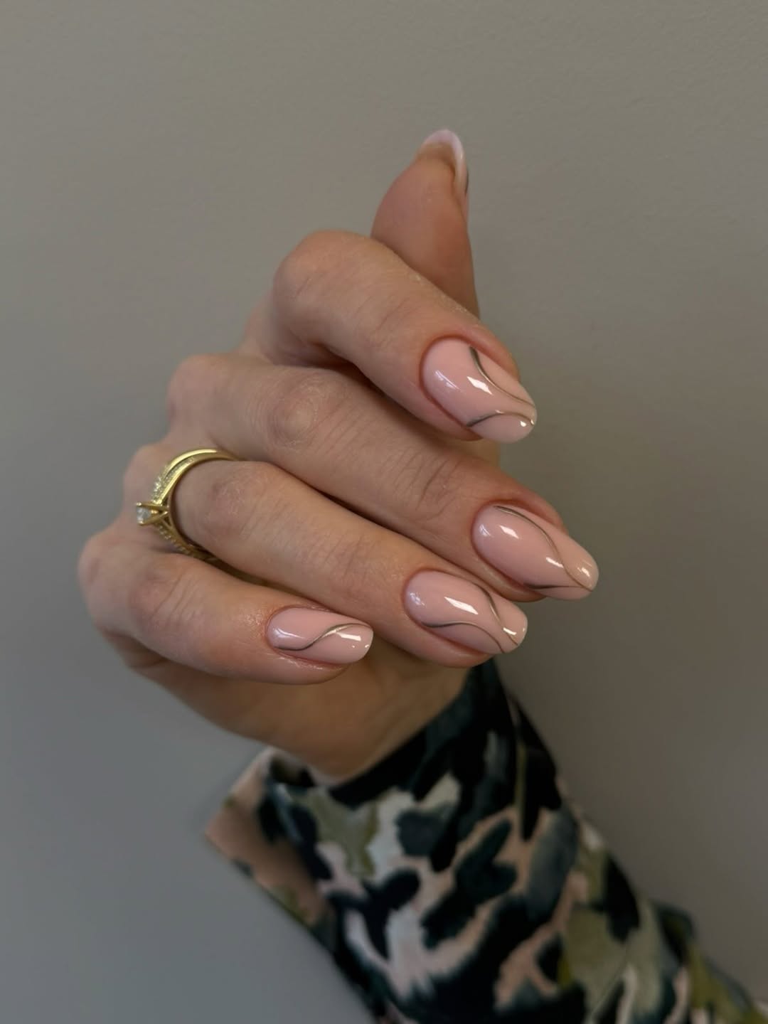 Glossy Nude Swirl Almond Nails