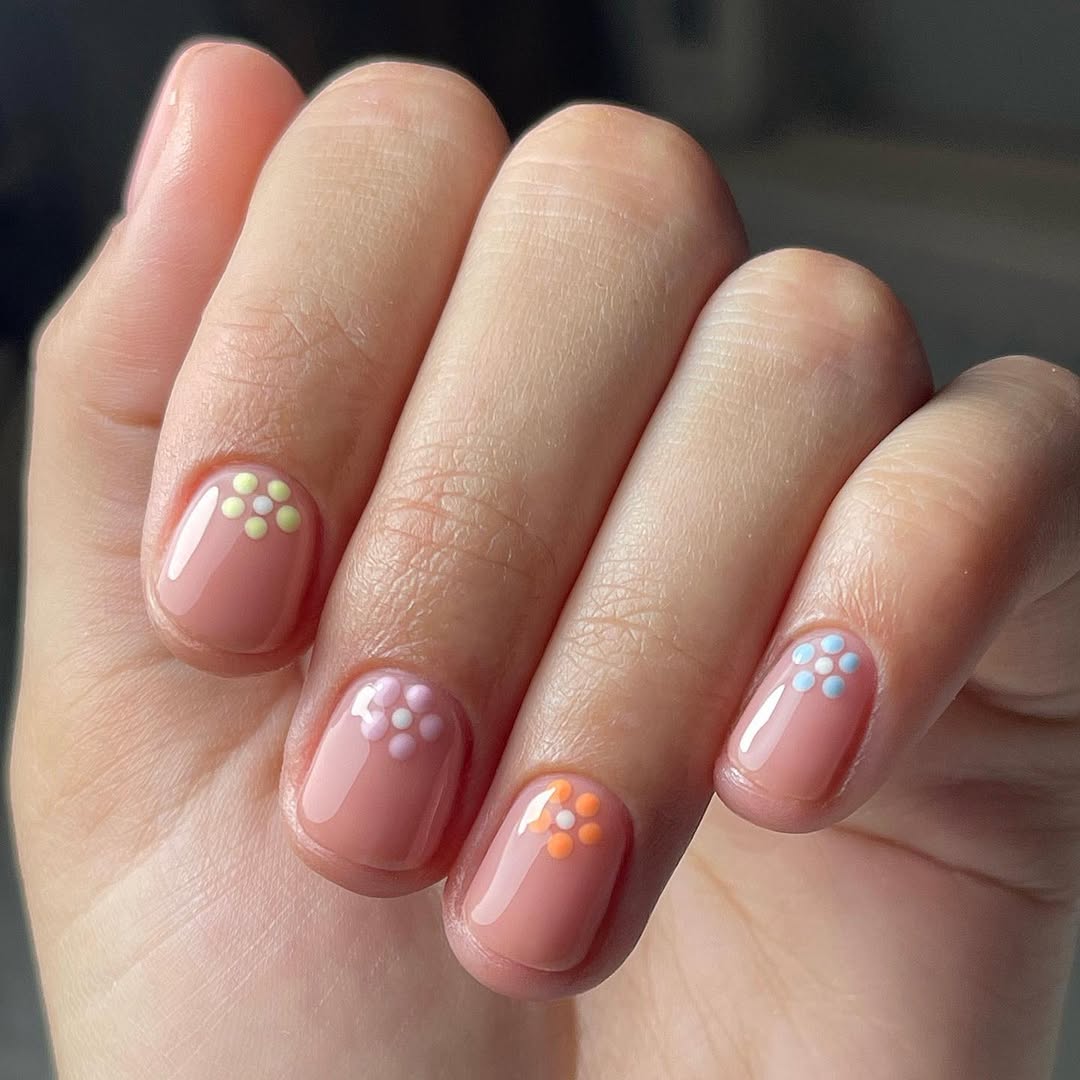 Glossy Nude With Pastel Daisy Accent Nails
