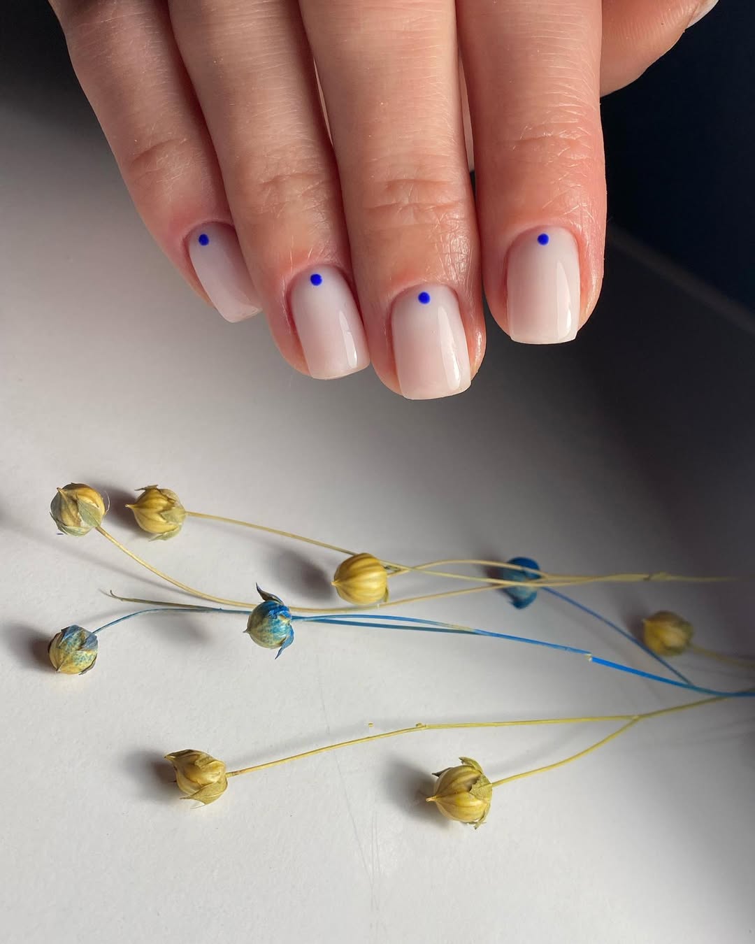 Milk White Glossy Nails With Tiny Blue Dots