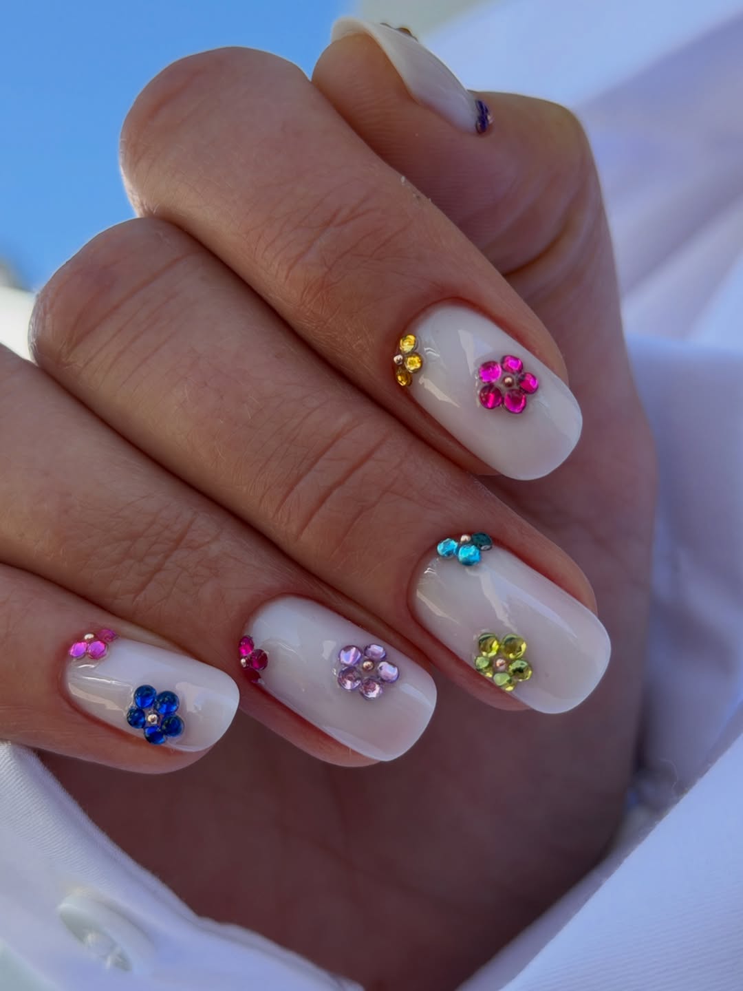 Milky White Nails with Colorful Gemstone Flower Charms