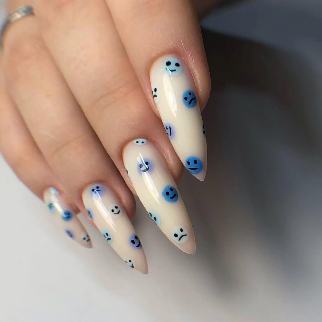 Milky White Stiletto Nails With Blue Smiley Faces