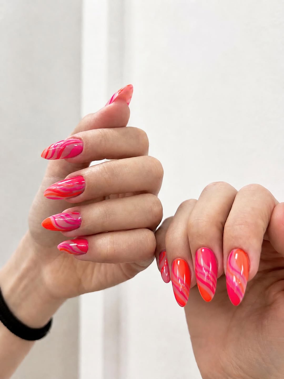 Neon Pink and Orange Swirl Almond Nails