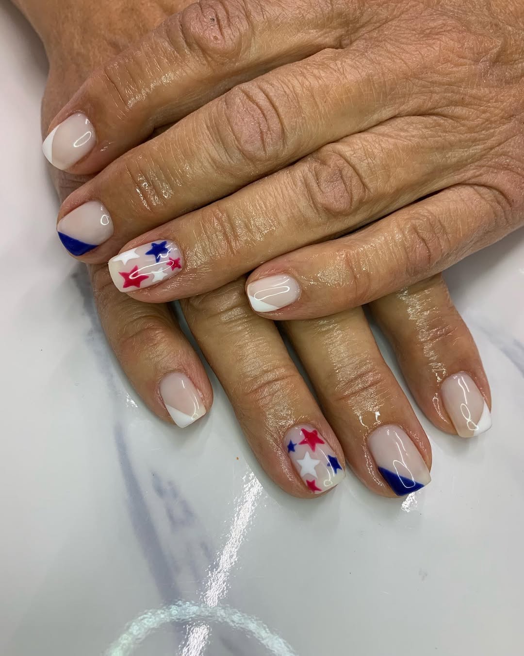 Patriotic Milky White Tips with Red, White, and Blue Stars