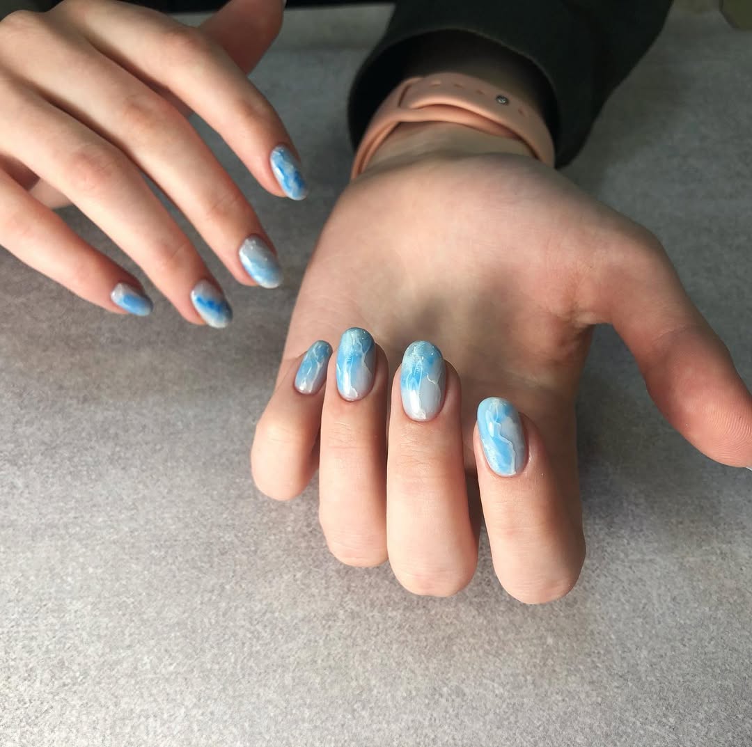 Soft Blue and White Cloud Swirl Oval Nails