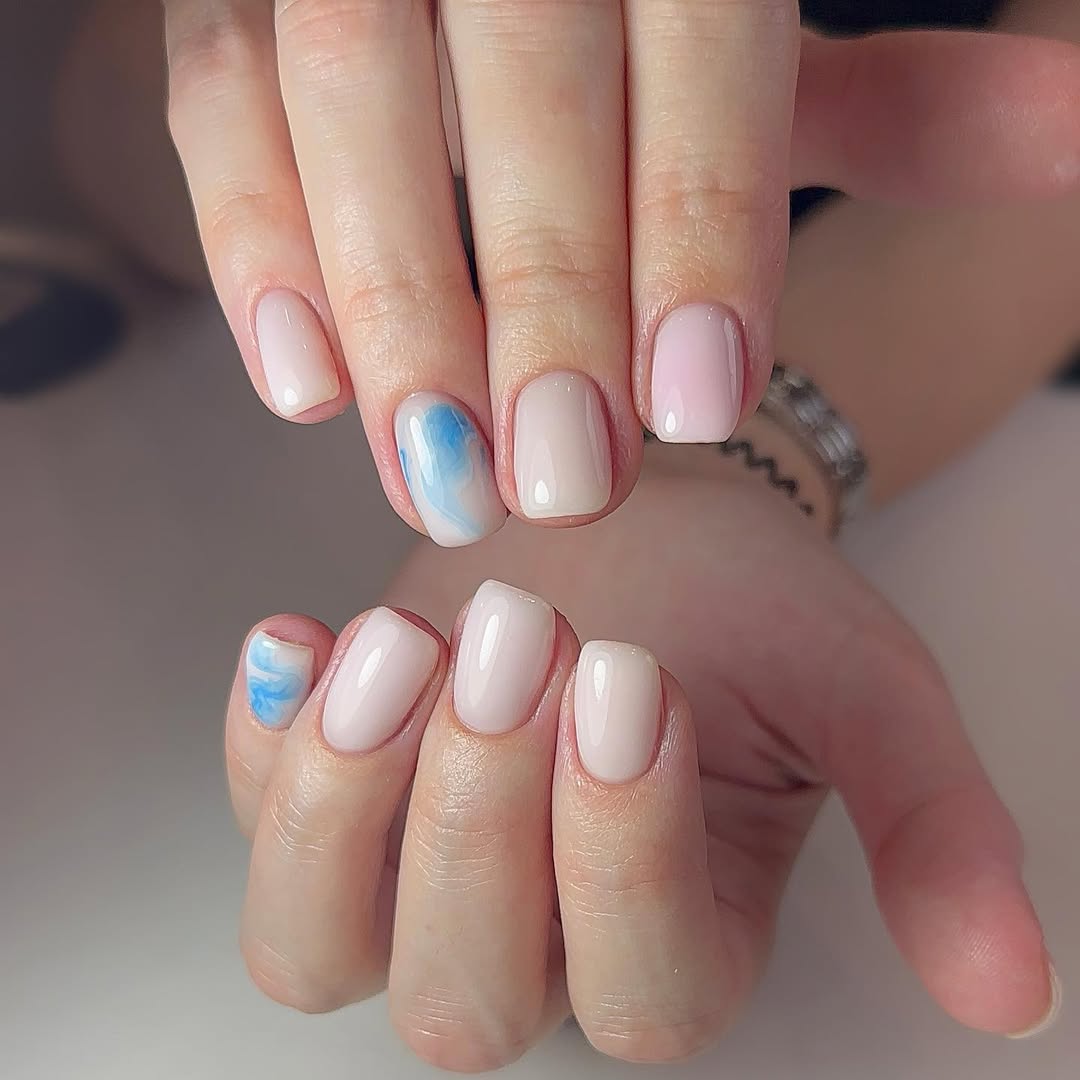 Soft Peach Gel Nails With Blue Marble Accent