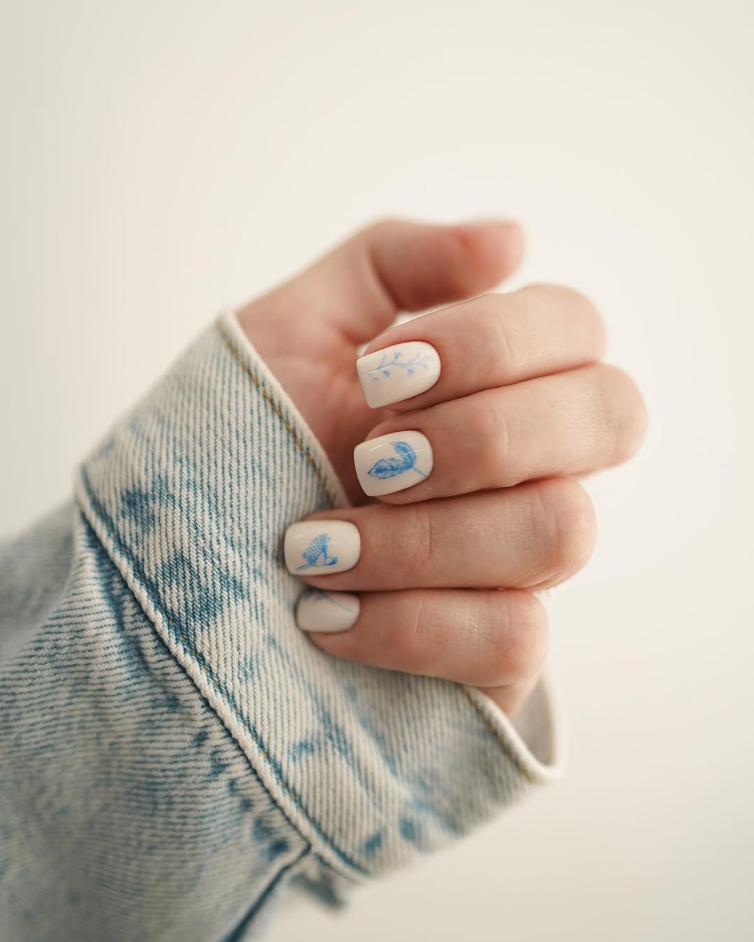 Soft White Nails With Delicate Blue Nature Art