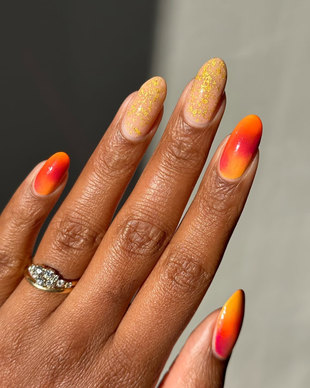 Sunset Aura Gold Flake Almond Nails