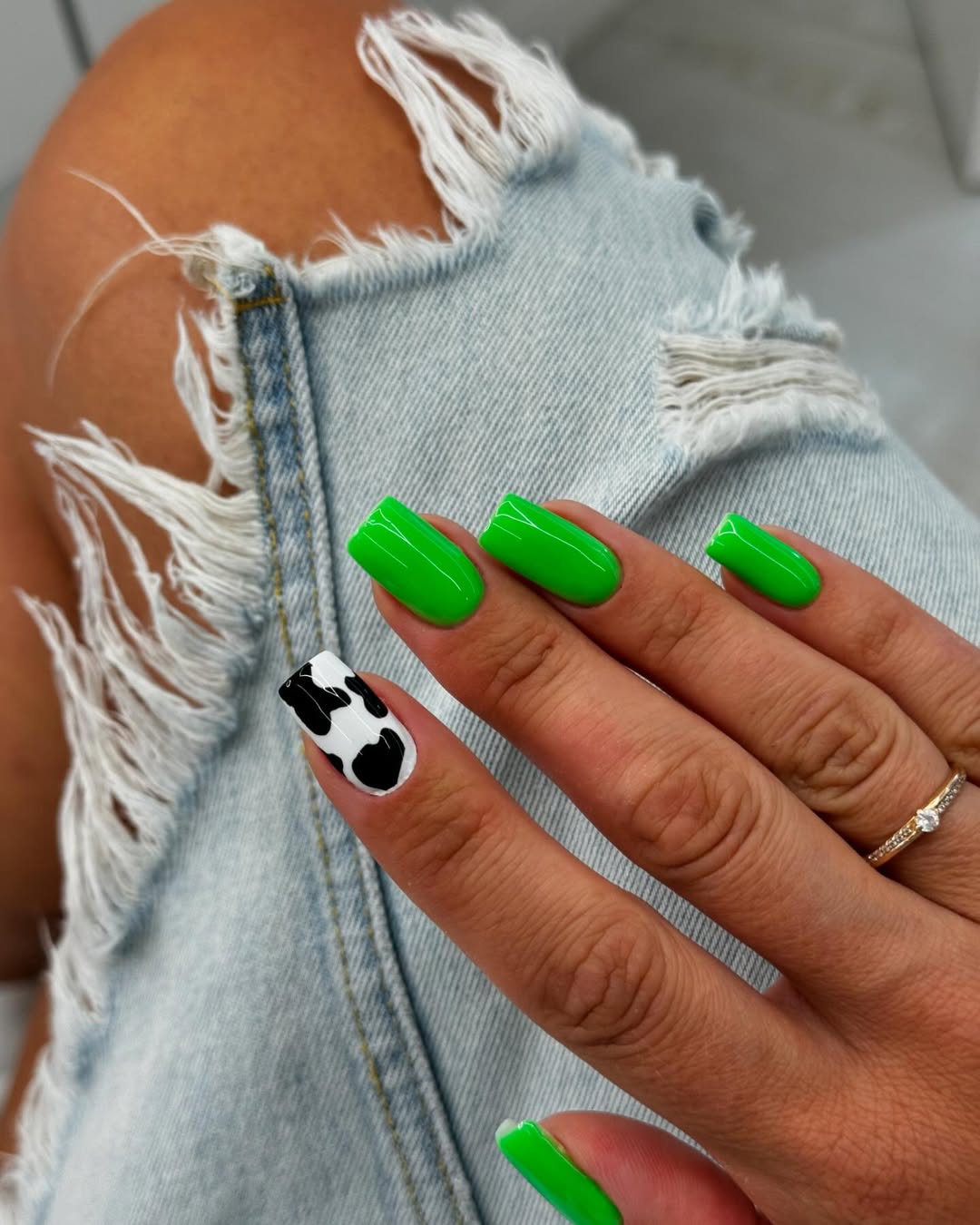 Vibrant Green Nails with Cow Print Accent