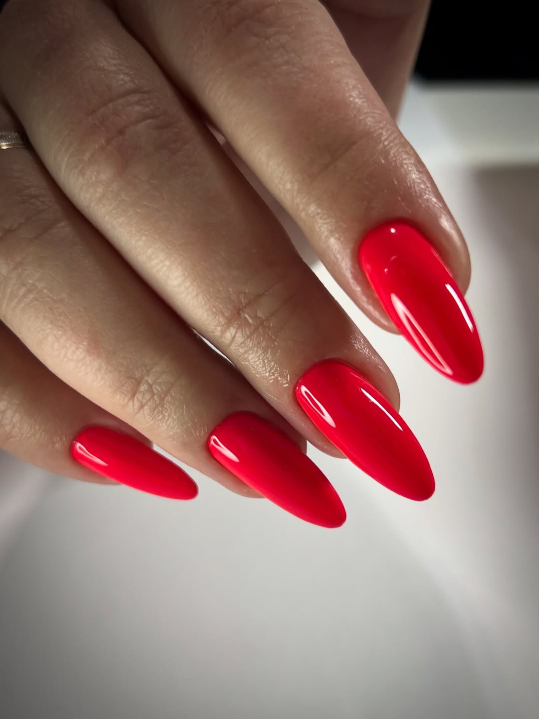 Vibrant Neon Pink Glossy Almond Nails