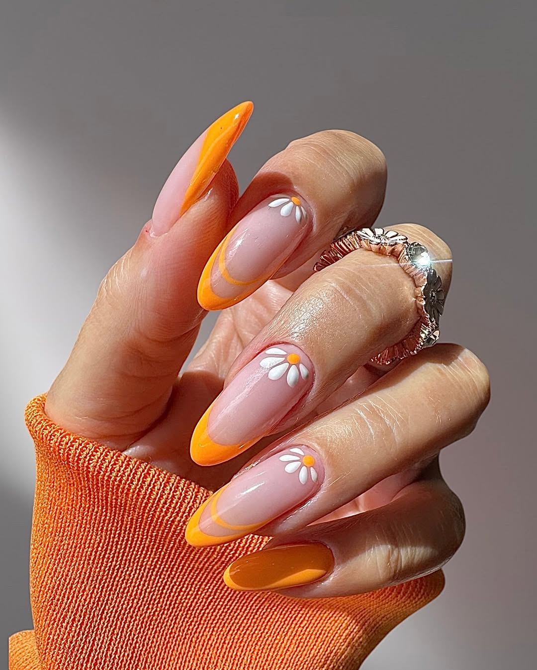 Vibrant Orange French Tips with Daisy Accents