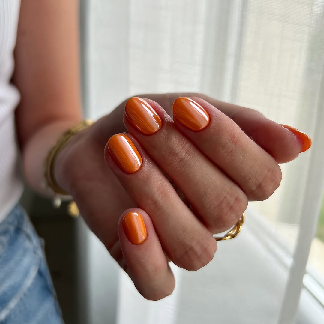 Vibrant Orange Glossy Glazed Donut Oval Nails