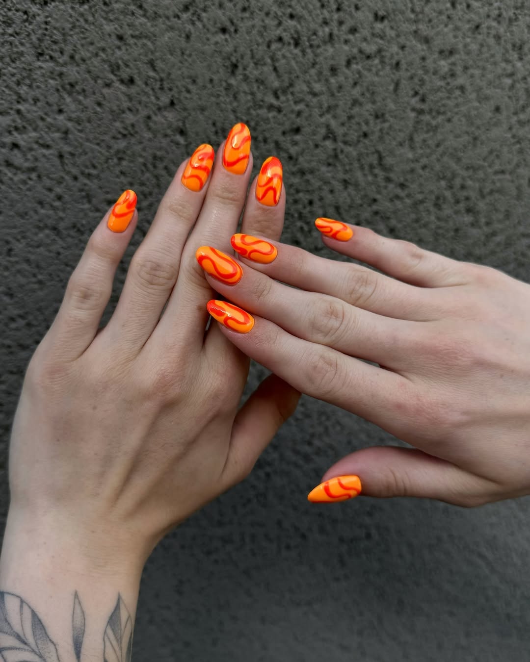 Vibrant Orange Swirl Glossy Medium Almond Nails
