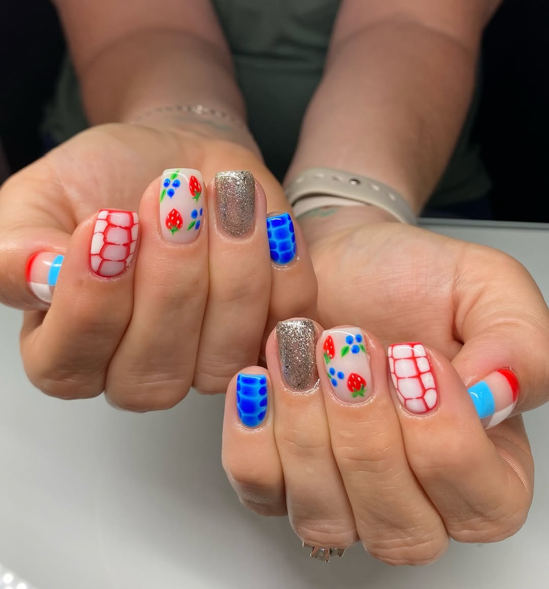Whimsical Red White Blue Berry Print Nails with Gold Glitter