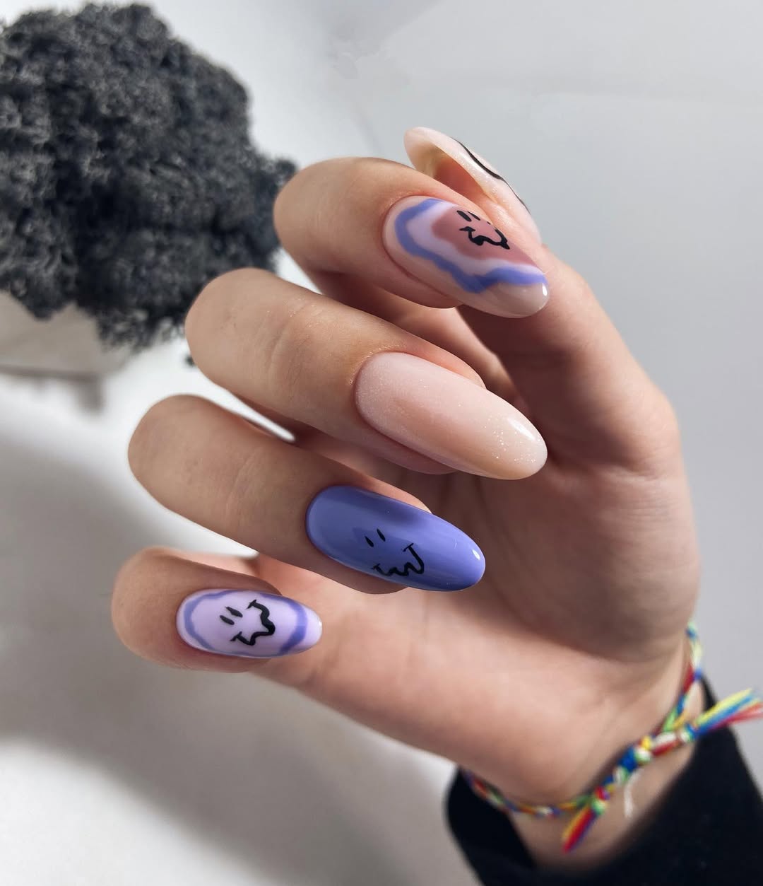 Whimsical Swirls and Wobbly Smileys Almond Nails