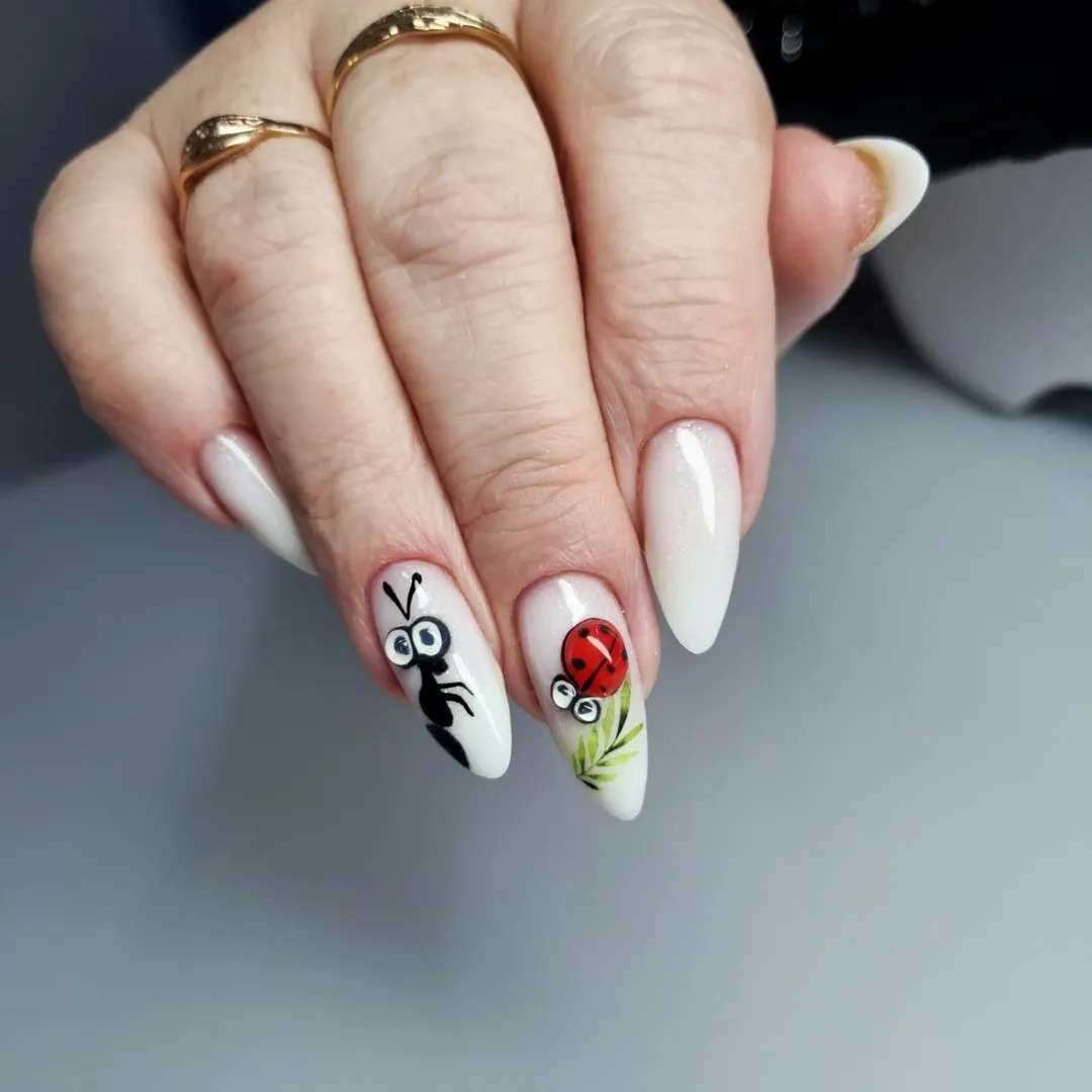 Whimsical White Shimmer Almond Nails With Cartoon Bugs
