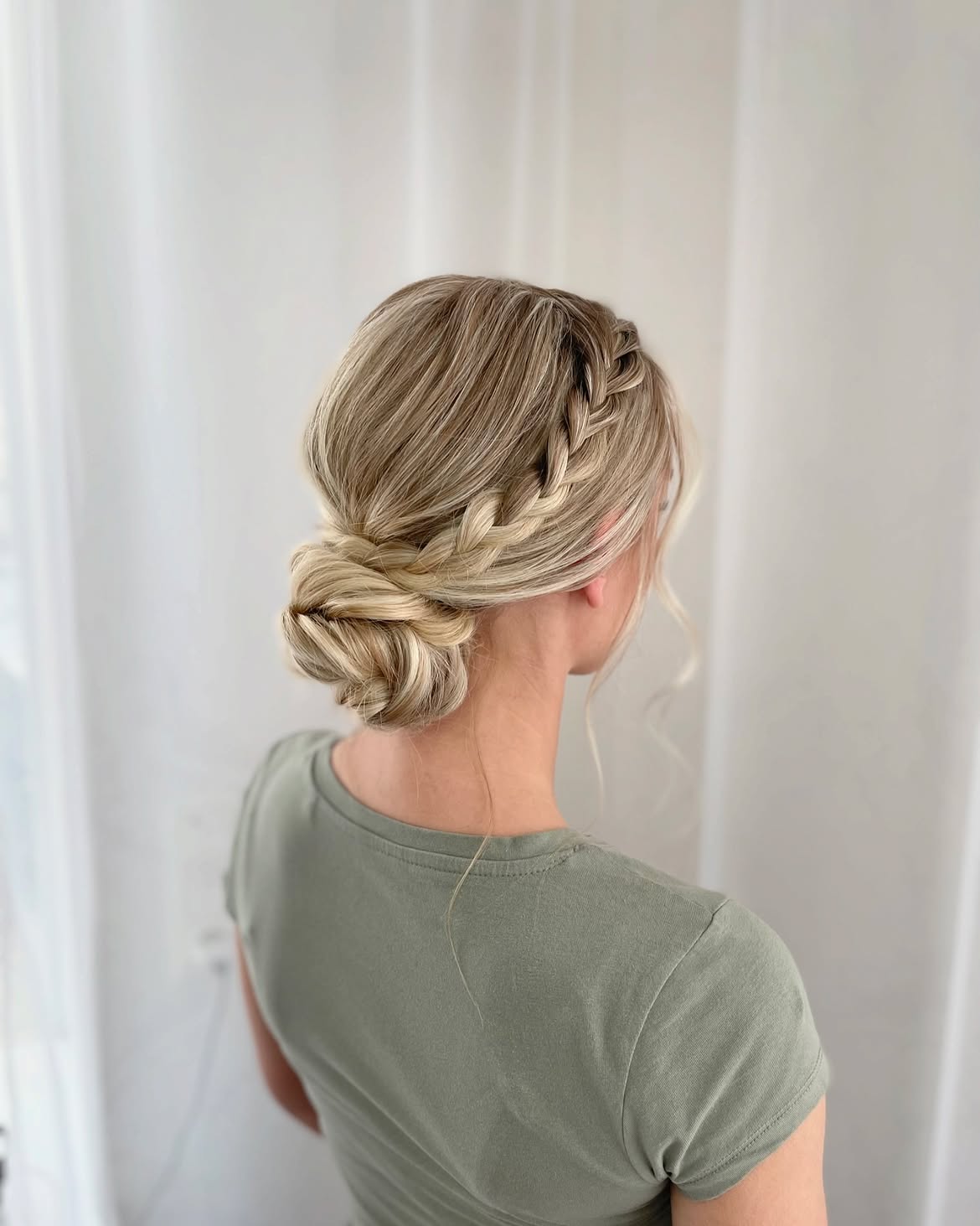 Braided Low Bun With Face Framing Tendrils