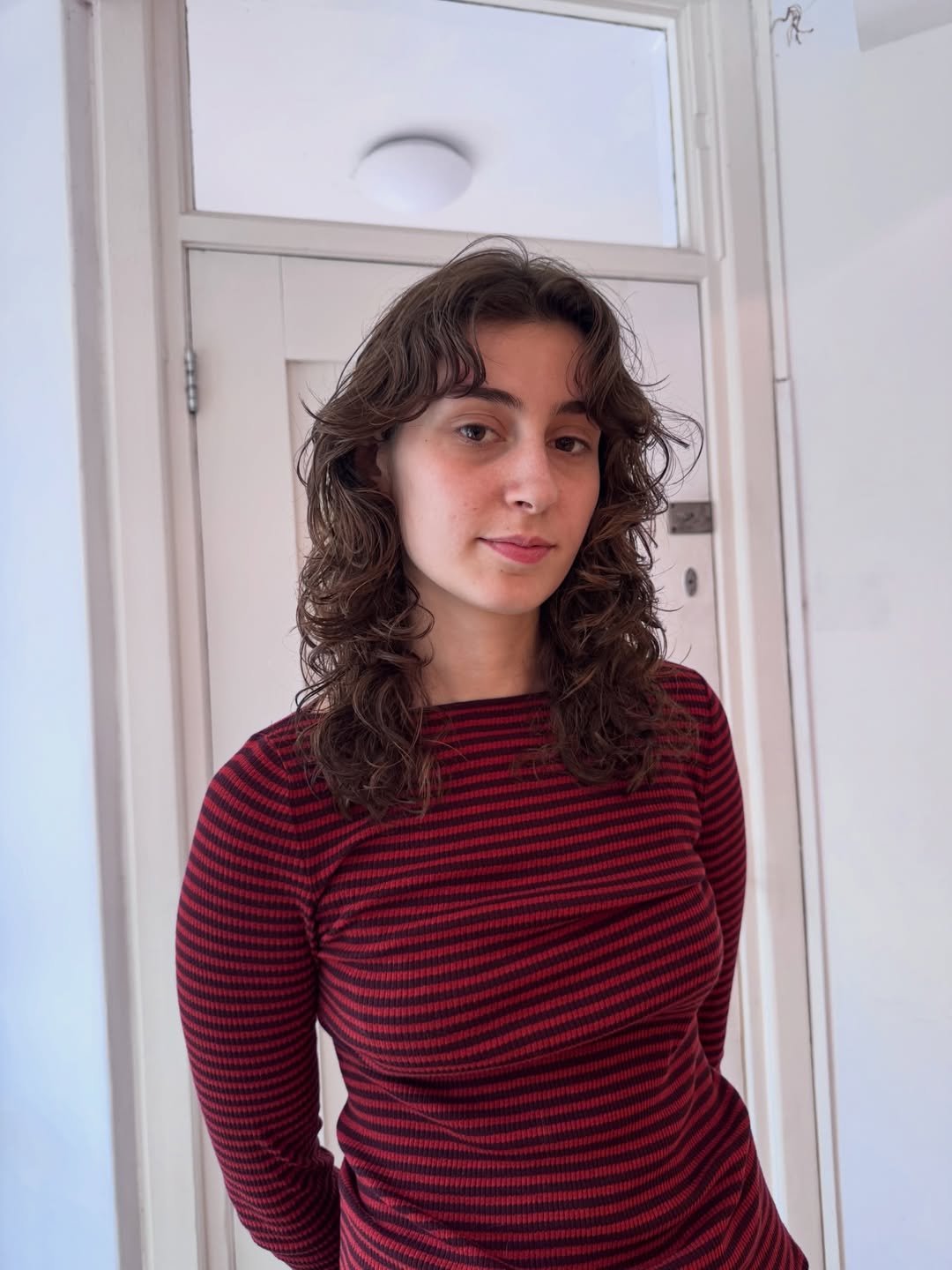 Choppy Mid-Length Layers With Loose Curls And Bangs