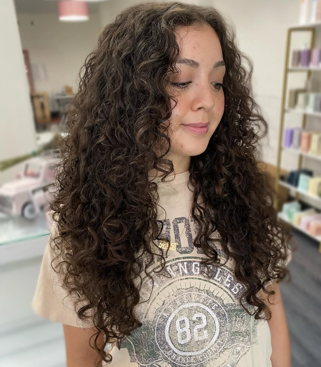Defined Long Curly Layers With Natural Highlights