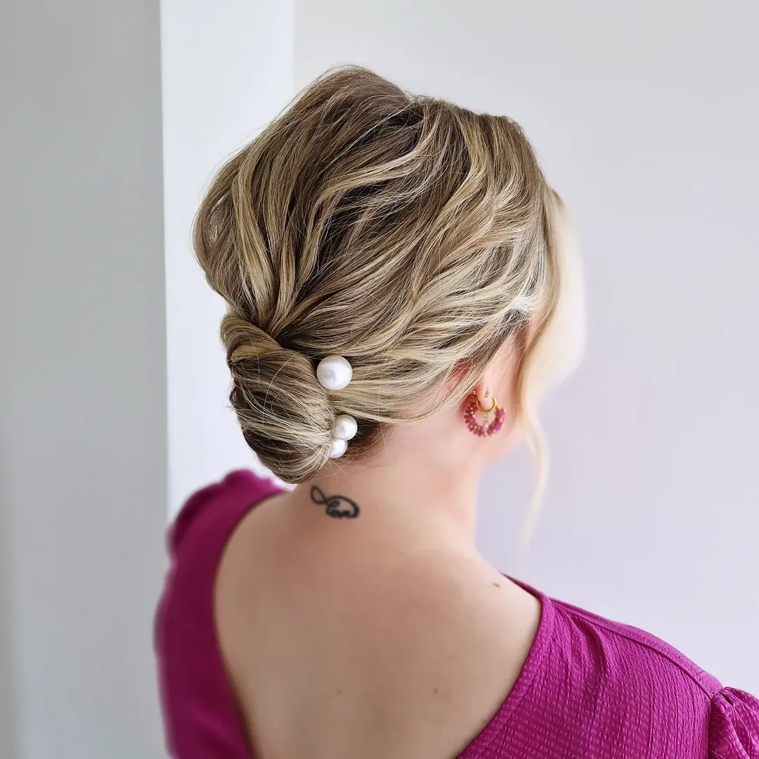 Elegant Low Bun Updo With Pearl Accessories
