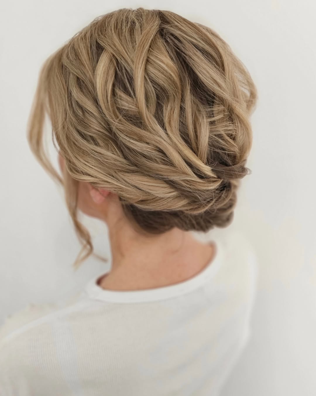 Elegant Twisted Low Updo With Face Framing Tendrils