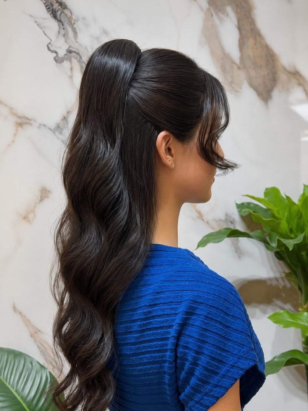 High Ponytail With Voluminous Waves & Face-Framing Tendrils