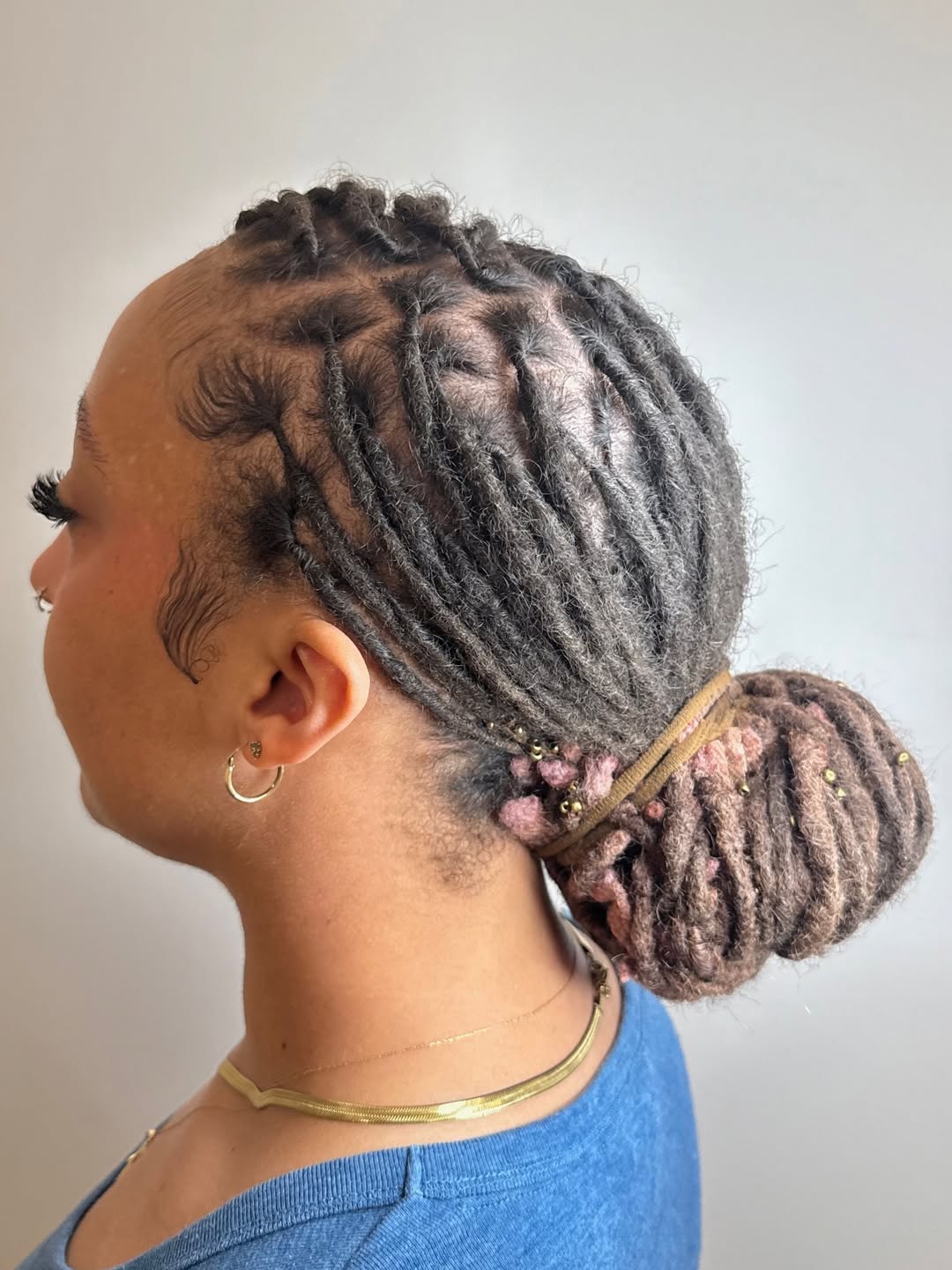 Locs Bun With Pastel Pink Tips And Slicked Edges