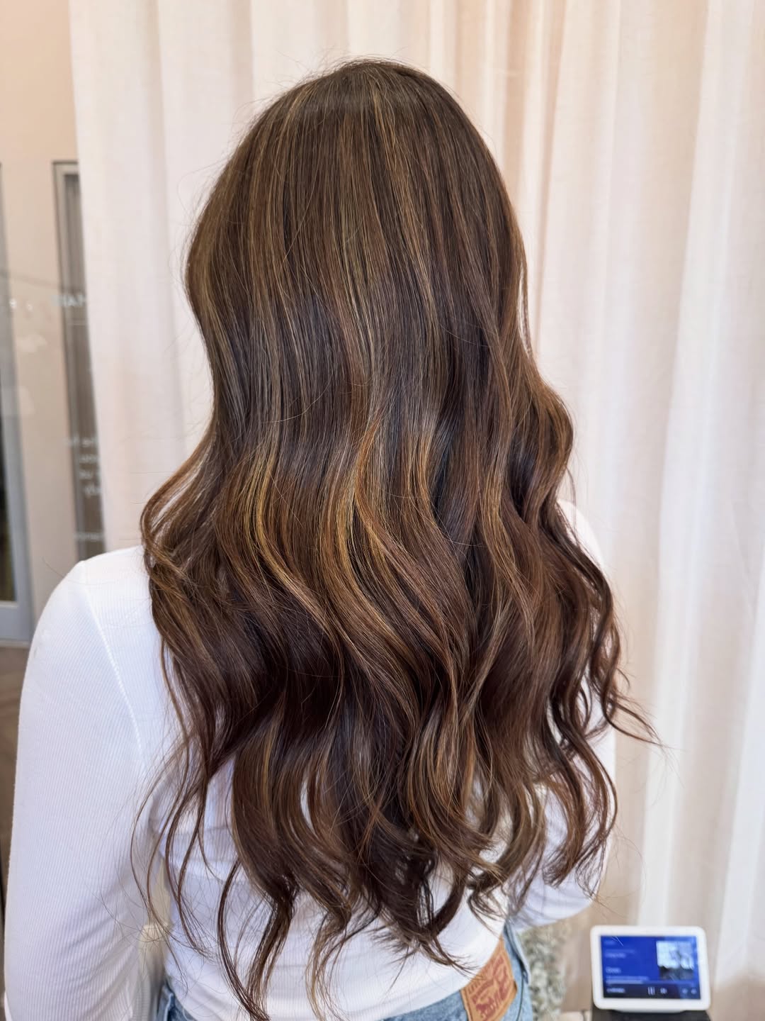 Rich Warm Highlights On Long Brunette Waves