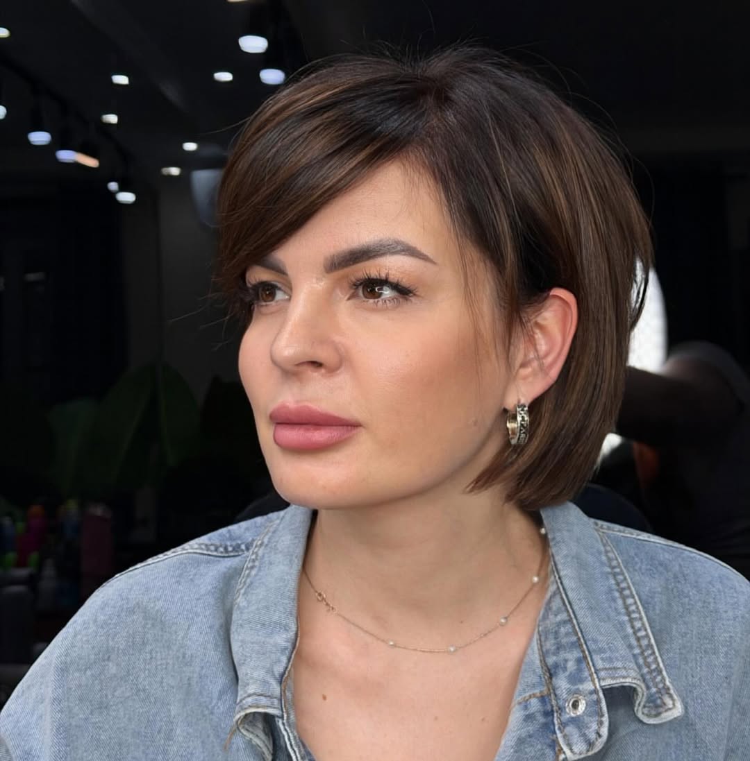 Sleek Side-Swept Bob with Warm Brunette Highlights