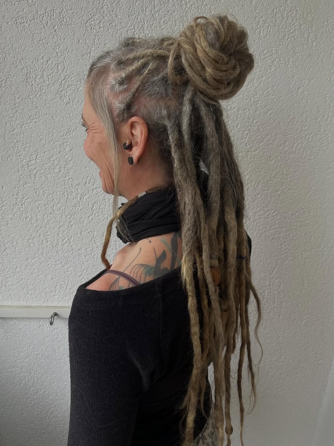 Updo Locs With Loose Strands And Bun