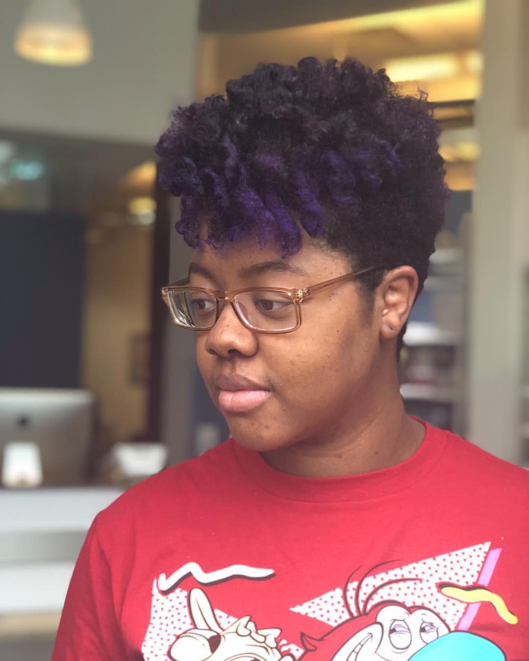 Vibrant Purple Accents On Natural Coily Cut