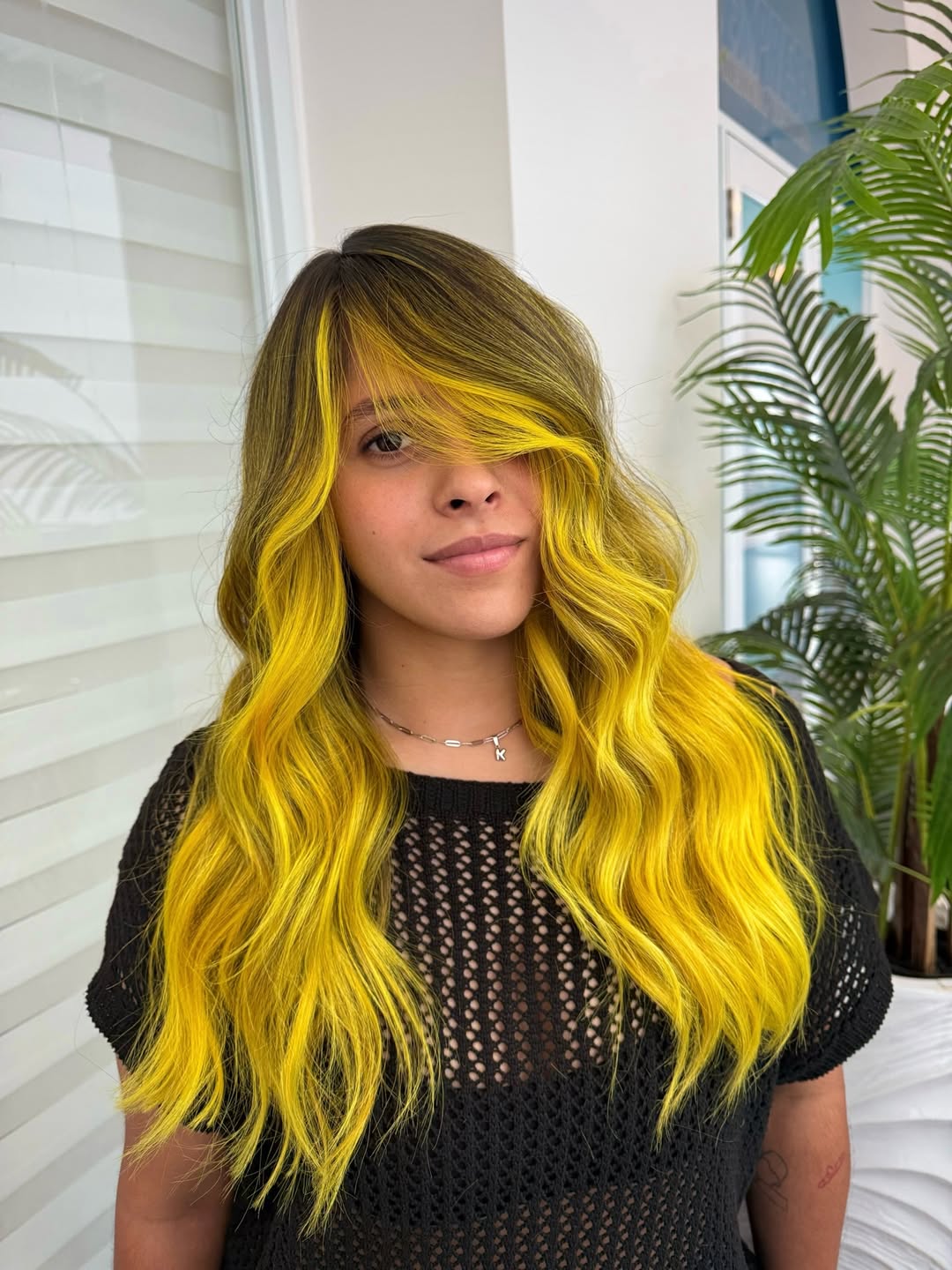 Vibrant Yellow Wavy Hair With Dark Roots
