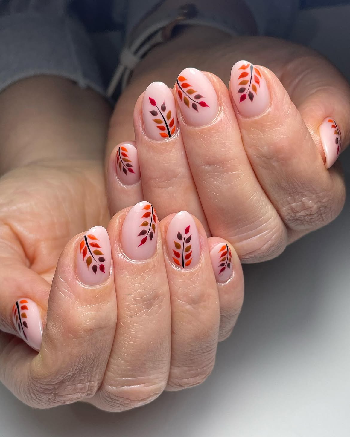 Enchanting Fall Leaf Art on Milky Oval Nails