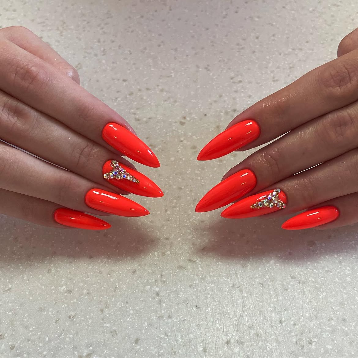 Neon Orange Stiletto Nails with Crystal Accents