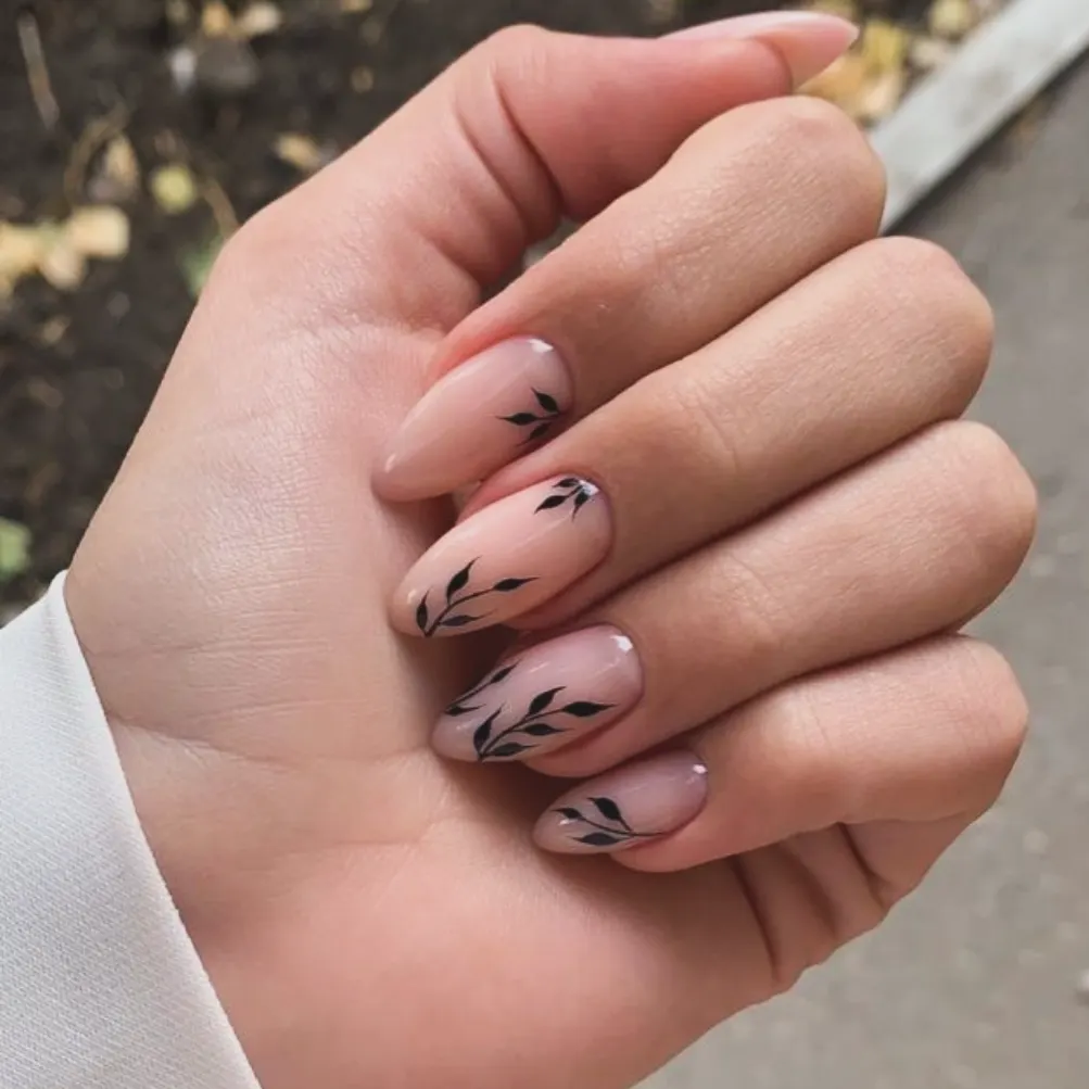 Sheer Nude Almond Nails with Black Leaf Accents