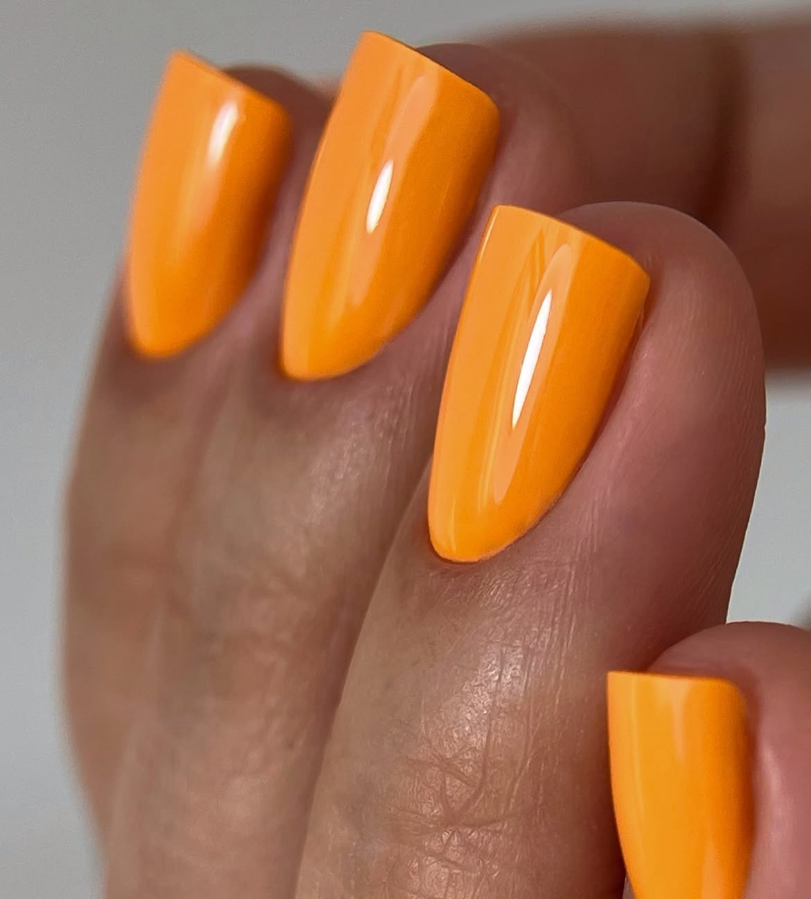 Vibrant Orange Almond Glossy Nails