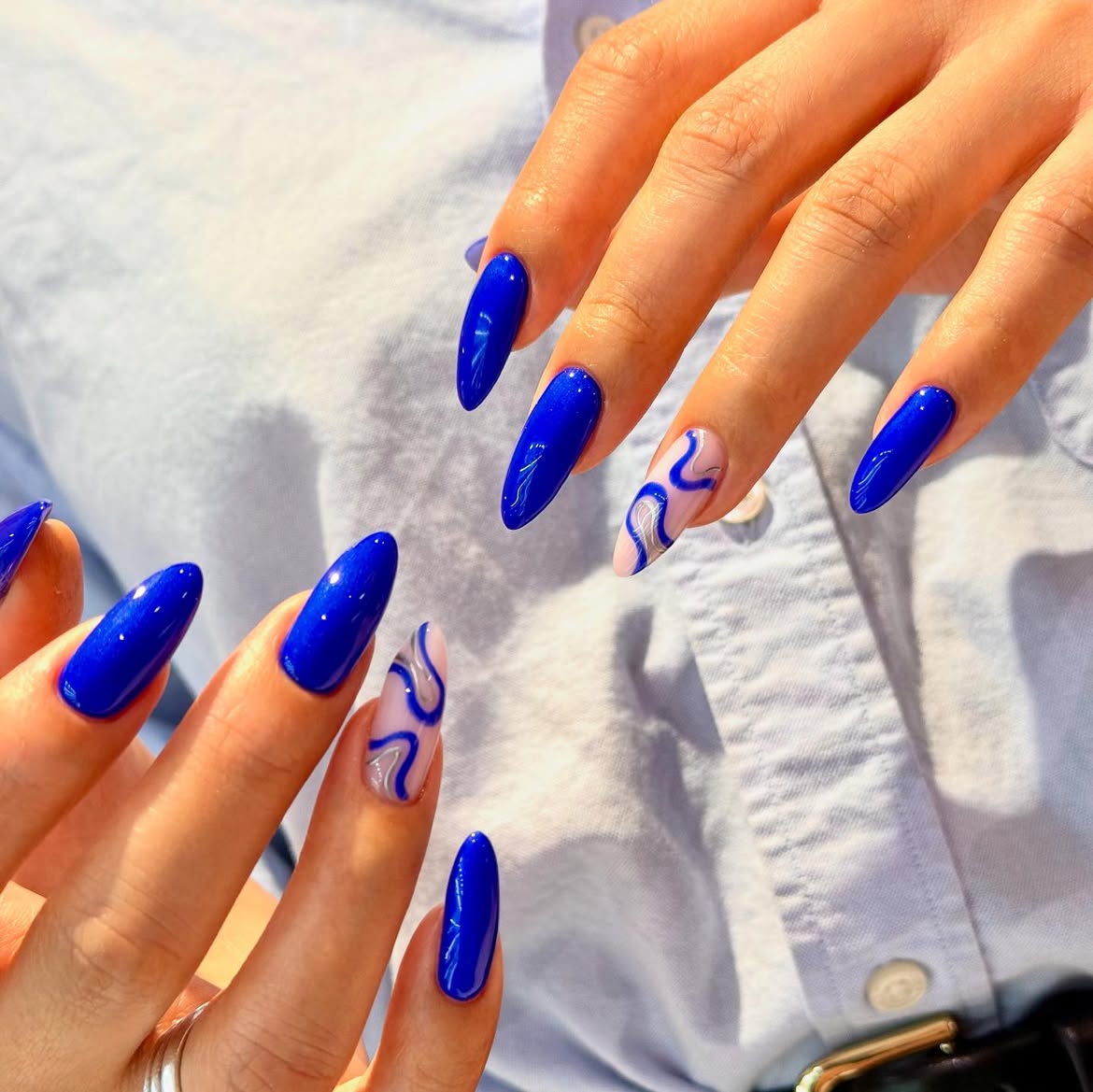 Vivid Blue Abstract Swirl Almond Nails
