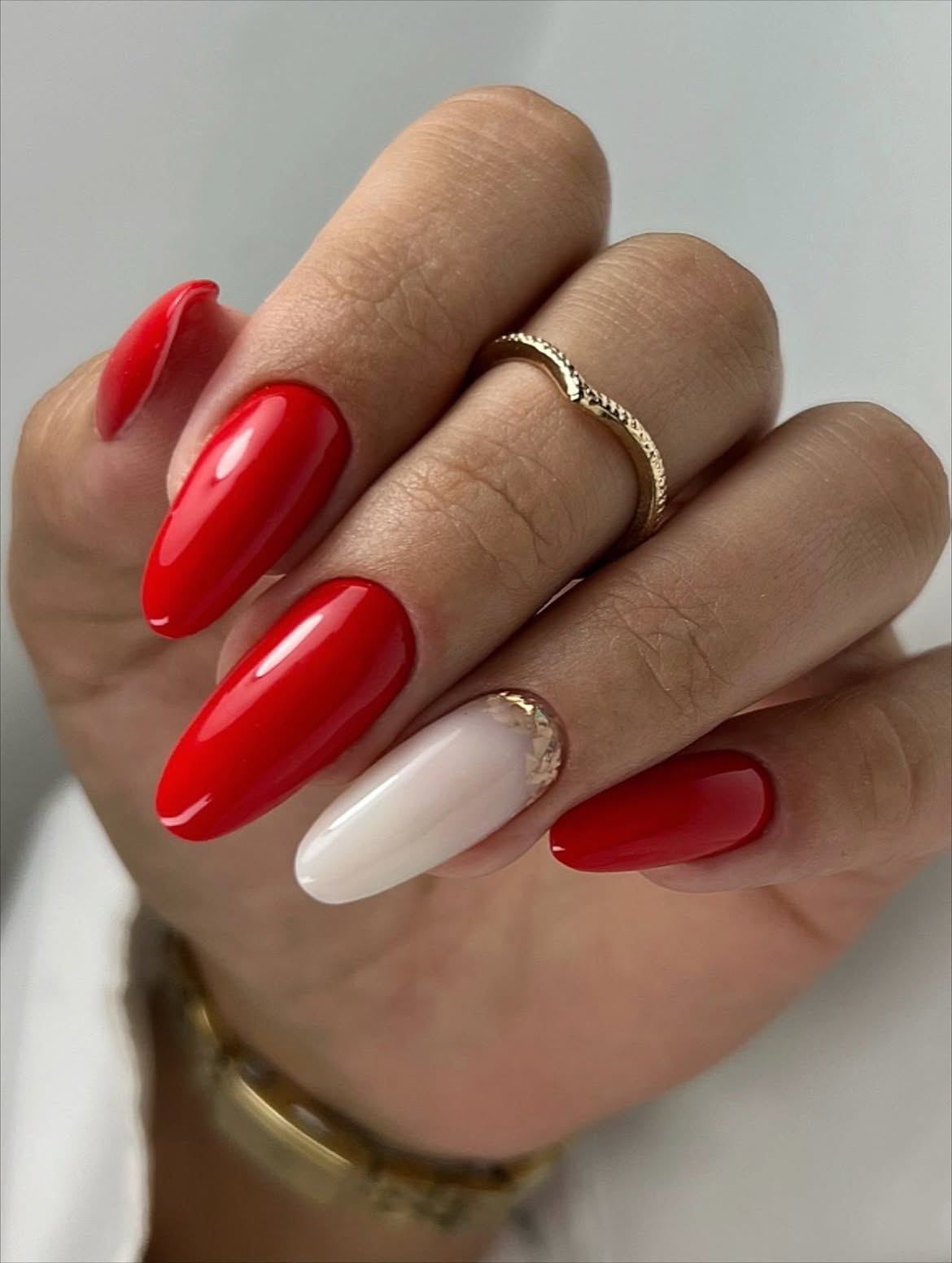 Vivid Red Almond Nails with Gold Flakes Accent